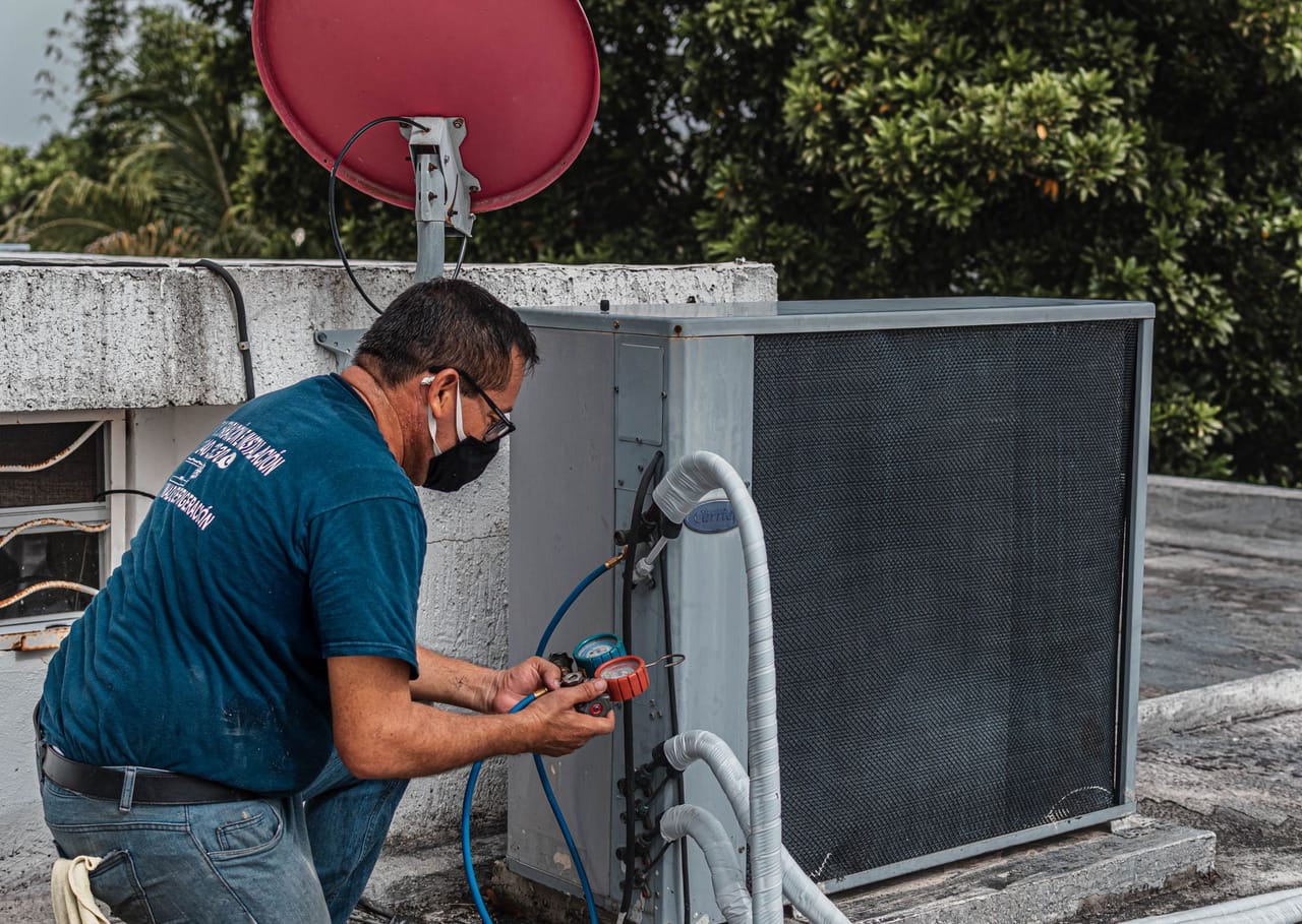 Technician servicing a rooftop unit