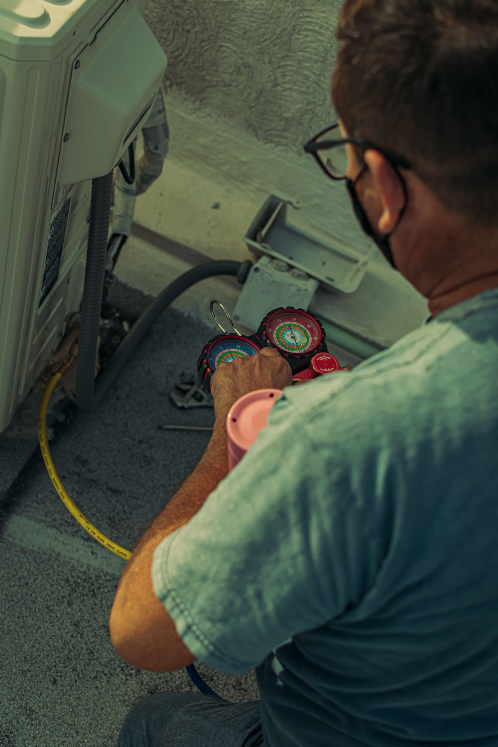 Technician checking refrigerant pressure